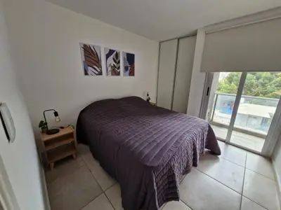 a bedroom with a purple bed and a window at Espacio C Av PUEYRREDÓN con estacionamiento in Cordoba