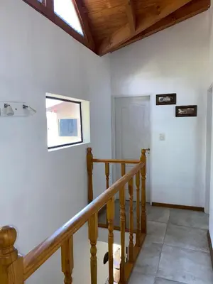a staircase in a house with a wooden ceiling at Cabaña Rubí, Complejo El Colibrí in Villa del Dique