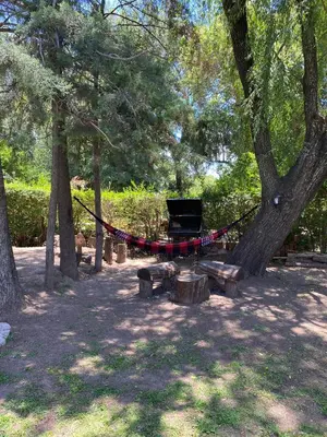 a hammock tied to a tree in a park at Cabaña Rubí, Complejo El Colibrí in Villa del Dique