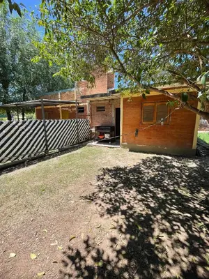 a house with a fence in front of it at Cabañas Mi Ángel in Villa Cura Brochero