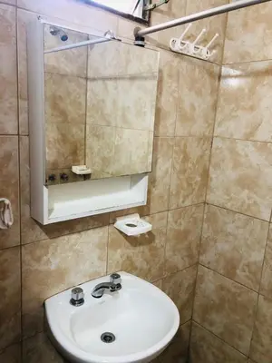 a bathroom with a sink and a mirror at Cabañas Mi Ángel in Villa Cura Brochero