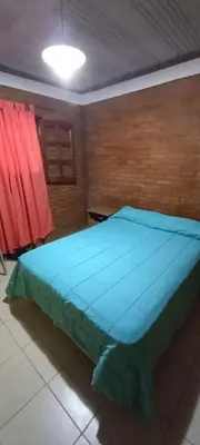 a bedroom with a blue bed in a room at Cabañas Mi Ángel in Villa Cura Brochero