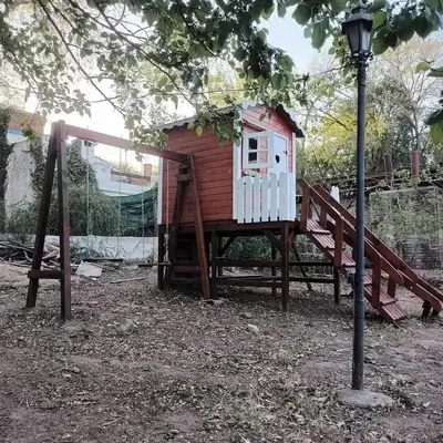 a play house on a playground with a street light at Chalet los aromos in Villa Los Aromos