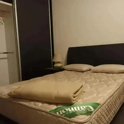 a bed sitting in a bedroom next to a mirror at Chalet los aromos in Villa Los Aromos