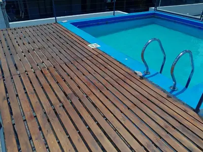 a swimming pool with a wooden deck and a swimming pooliterator at Abuela Betty in Villa Carlos Paz