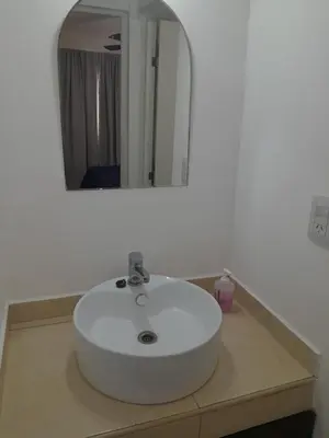 a white sink in a bathroom with a mirror at Abuela Betty in Villa Carlos Paz