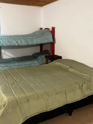 a bedroom with two bunk beds in a room at Habitaciones Monarcas in Villa Carlos Paz
