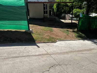 a house with a green covering on the side of a street at Habitaciones Monarcas in Villa Carlos Paz