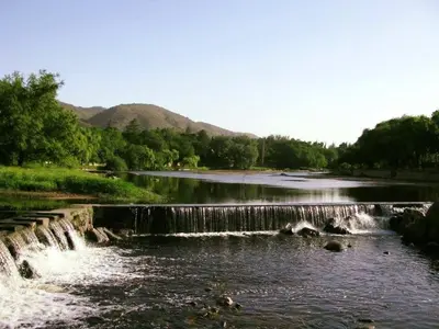a river with a waterfall in the middle at Habitaciones Monarcas in Villa Carlos Paz