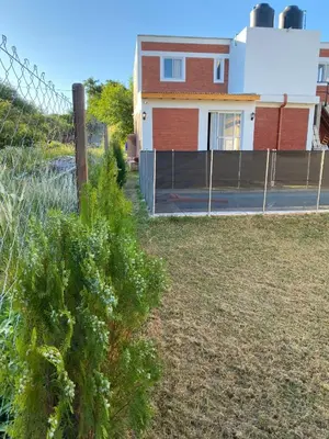 a house with a fence in front of a yard at El Rincon de las Marias Casa en Planta Alta in San Lorenzo