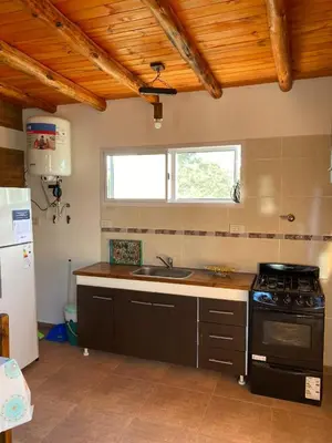 a kitchen with a sink and a stove top oven at El Rincon de las Marias Casa en Planta Alta in San Lorenzo