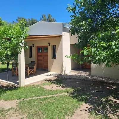 a small white house with a wooden door at la vinca serrana in San Javier