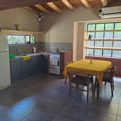a kitchen with a table with a yellow table cloth on it at la vinca serrana in San Javier