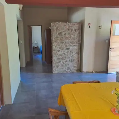 a room with a table and a stone wall at la vinca serrana in San Javier