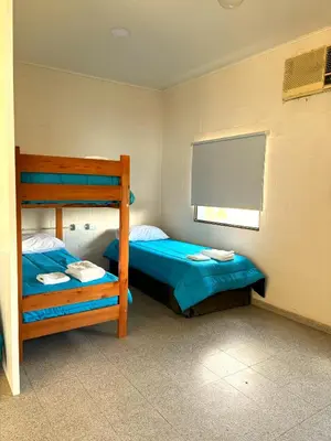 a bedroom with two bunk beds and a window at La Fabrica in Yacanto