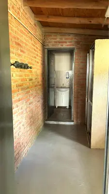 an empty room with a brick wall at La Fabrica in Yacanto