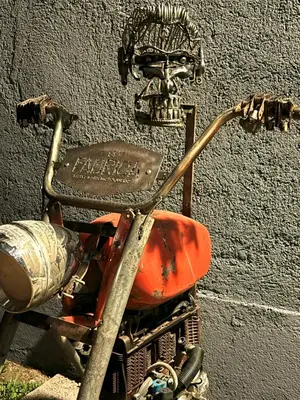 a motorcycle with a skull on the side of a wall at La Fabrica in Yacanto
