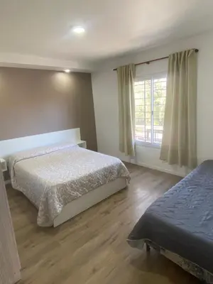 a bedroom with two beds and a window at Refugio Del Lago in Villa Carlos Paz