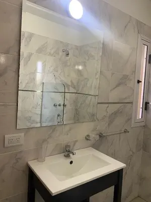 a bathroom with a sink and a mirror at Refugio Del Lago in Villa Carlos Paz