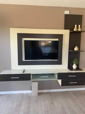 a flat screen tv sitting on top of a entertainment center at Refugio Del Lago in Villa Carlos Paz