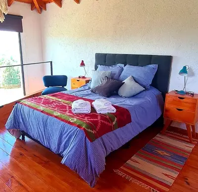 a bedroom with a large bed with two towels on it at Eco Aldea in Villa Ciudad Parque