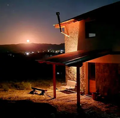 a building with a table and a bench next to it at Eco Aldea in Villa Ciudad Parque
