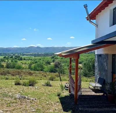 a porch of a house with a bench next to it at Eco Aldea in Villa Ciudad Parque