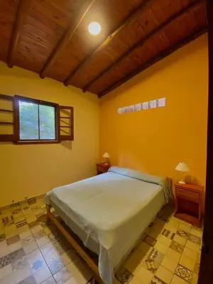 a bedroom with a large bed and a window at CASA del RIO in Villa Ciudad Parque