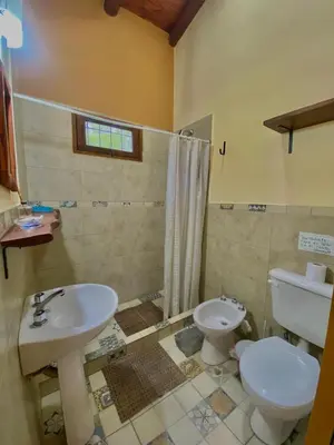 a bathroom with a sink and a toilet at CASA del RIO in Villa Ciudad Parque