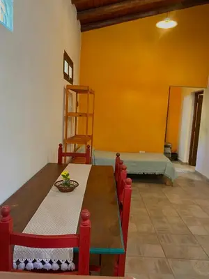 a dining room with a table and chairs and a ladder at CASA del RIO in Villa Ciudad Parque