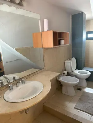 a bathroom with a sink and a toilet and a mirror at Casa Spilimbergo in Cordoba