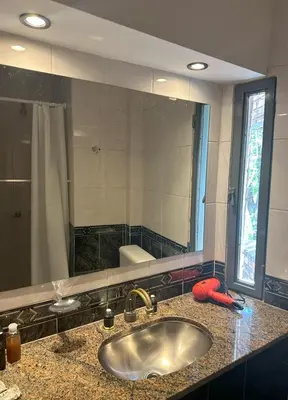 a bathroom with a sink and a large mirror at Casa Spilimbergo in Cordoba
