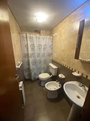 a bathroom with two toilets and a sink at Familiar Centrico PB Patio Cochera Amenities in Villa Carlos Paz
