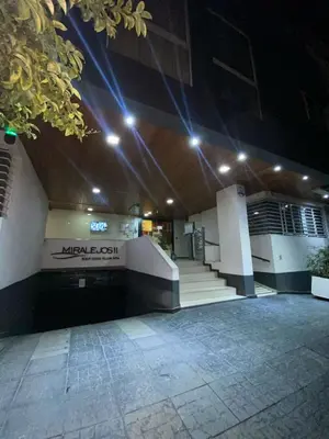 a building with lights on top of it at night at Familiar Centrico PB Patio Cochera Amenities in Villa Carlos Paz