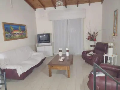 a living room with a couch and a coffee table at CASA CENTRICA con SALIDA al RIO in Mina Clavero