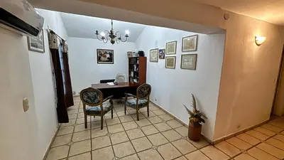 a dining room with a table and two chairs at Gran casa en Villa Del Lago in Villa Carlos Paz