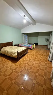 a bedroom with a bed and a wooden floor at Gran casa en Villa Del Lago in Villa Carlos Paz