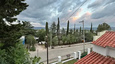 a view of a street with a fence and trees at Gran casa en Villa Del Lago in Villa Carlos Paz