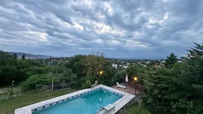a swimming pool with a view of a city at Gran casa en Villa Del Lago in Villa Carlos Paz