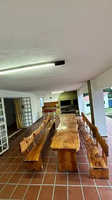 a group of wooden benches in a room at Gran casa en Villa Del Lago in Villa Carlos Paz