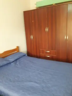 a bedroom with a bed and a wooden cabinet at Lo de Andres in Santa María