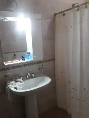 a bathroom with a sink and a mirror at Lo de Andres in Santa María