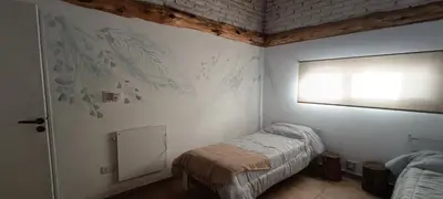 a small bedroom with a bed and a window at Casa Marie in Villa del Dique