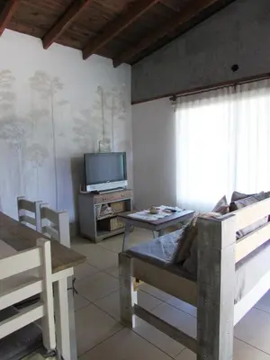 a living room with a bed and a tv at Casa Marie in Villa del Dique