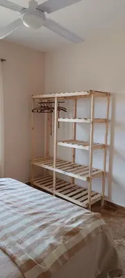 a bedroom with a bed and shelves in a room at Casa Marie in Villa del Dique