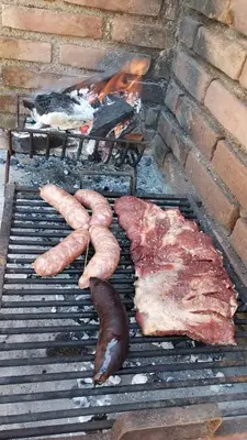 a grill with some meat and vegetables on it at Casa Marie in Villa del Dique