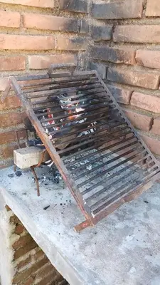 a metal grill sitting next to a brick wall at Casa Marie in Villa del Dique