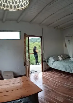 a person taking a picture of a room with a door at La calendula eco cabaña in Los Hornillos