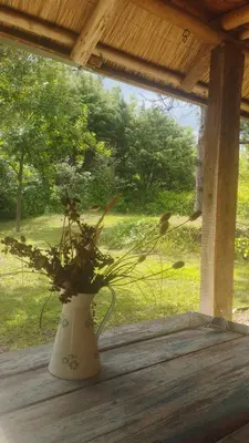 a vase with flowers in it sitting on a table at Cabaña Maitane in El Durazno