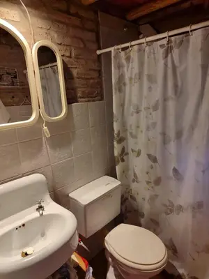 a bathroom with a toilet and a sink at Cabaña Maitane in El Durazno